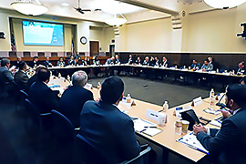 Group of officials sitting in a conference room.