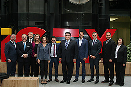 Texas Secretary of State Rolando Pablos standing with the delegation in front of  a building.
