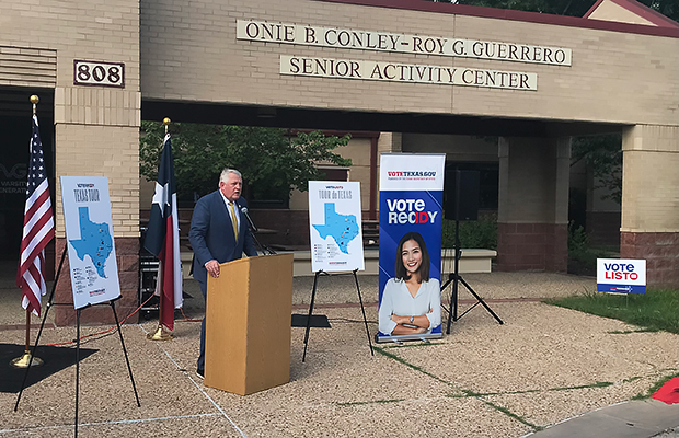 Secretary Scott standing in front of the Conley-Guerrero Building.
